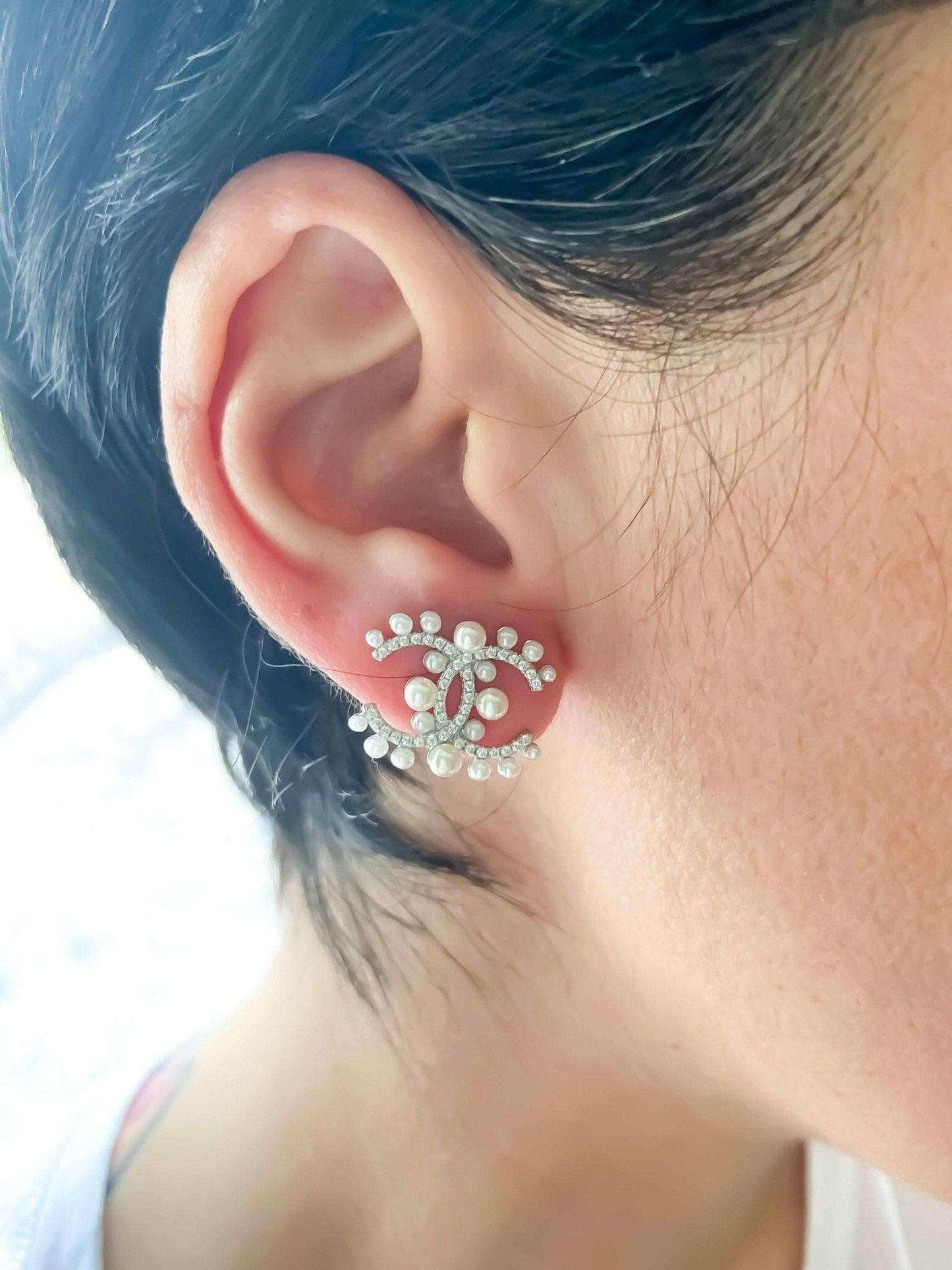 Authentic Chanel Pearl stud earrings in 925 sterling silver with rose gold and Italian stones on ear