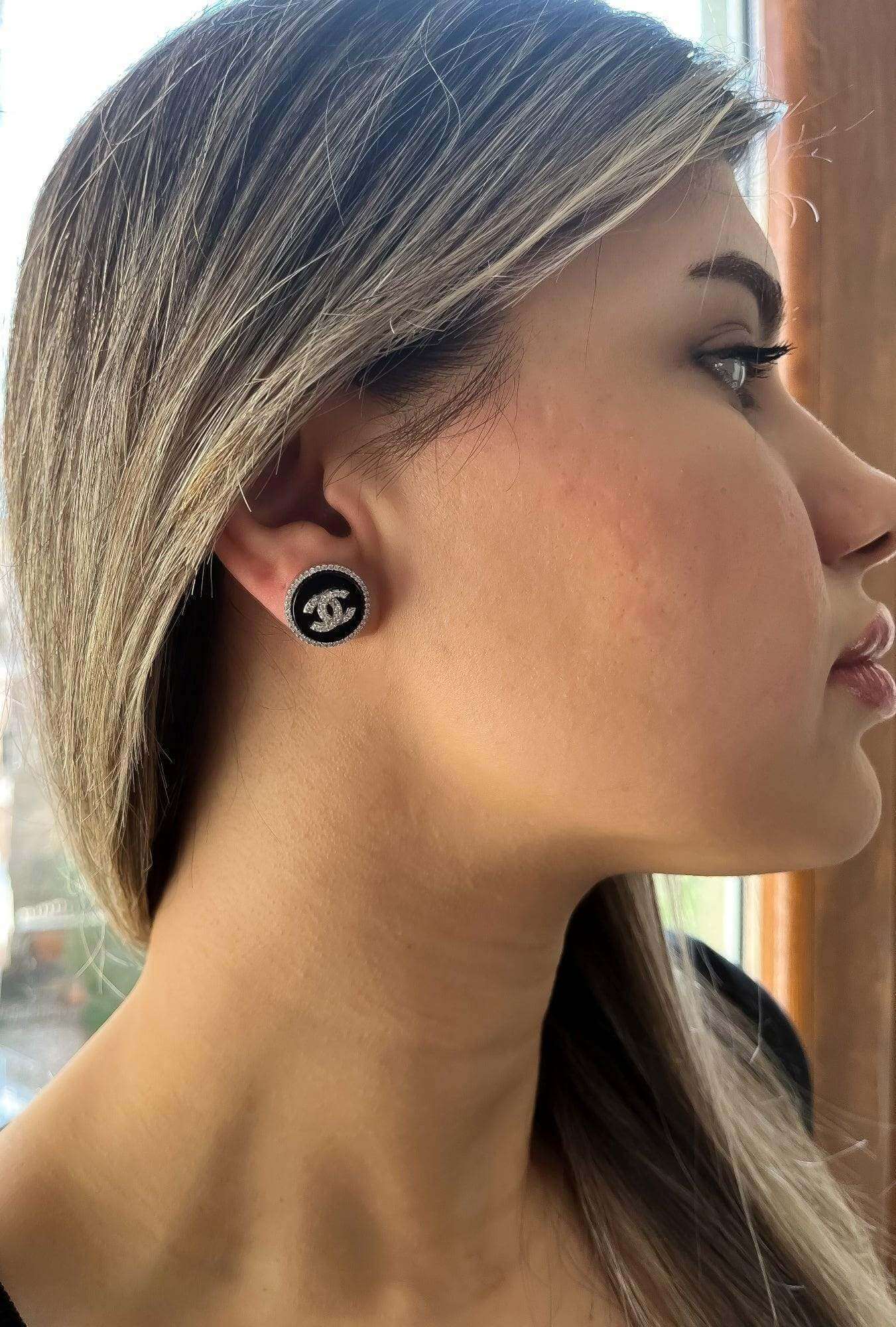 Vintage Chanel enamel 925 sterling silver earrings with white zircon baguette stones worn by woman