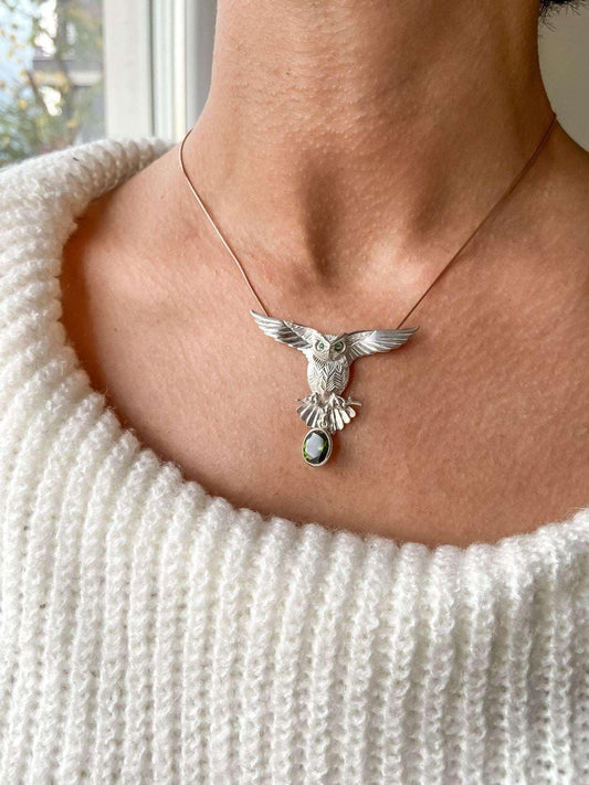 Peridot Stone 925 Silver Owl Design Necklace, Handmade Emerald Eyes OwOur Peridot Owl is 925 sterling silver and it is completely handcrafted. The eyes you see on it are decorated with emeralds.the bottom stone is the Peridot GemstonPeridot Stone