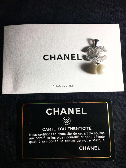 Authentic Chanel Jewelry 925 sterling silver necklace with pearl and baguette stones on Chanel authenticity card and envelope