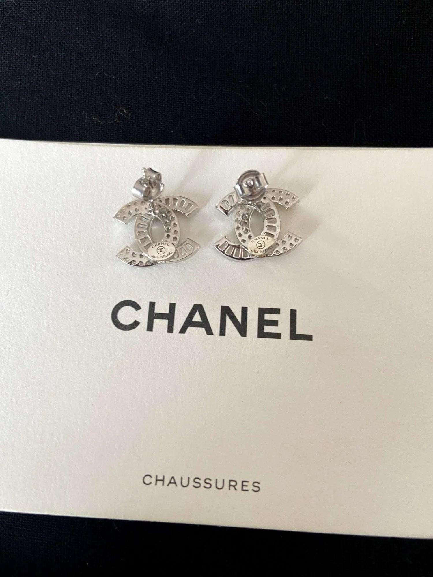 Authentic Chanel stud earrings in 925 sterling silver with baguette white zircon stones