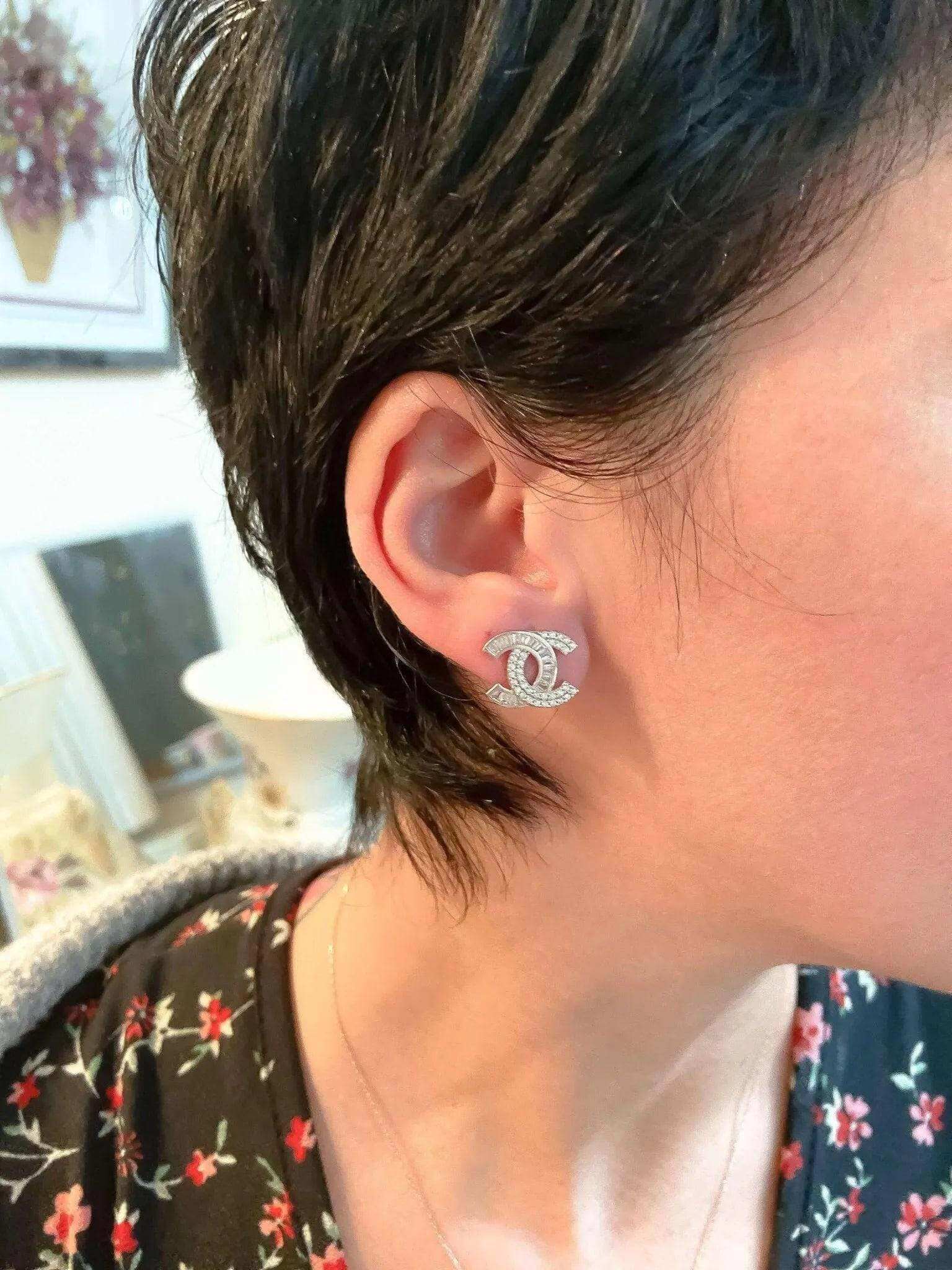 Authentic Chanel stud earrings 925 sterling silver with white zircon baguette stones worn on ear