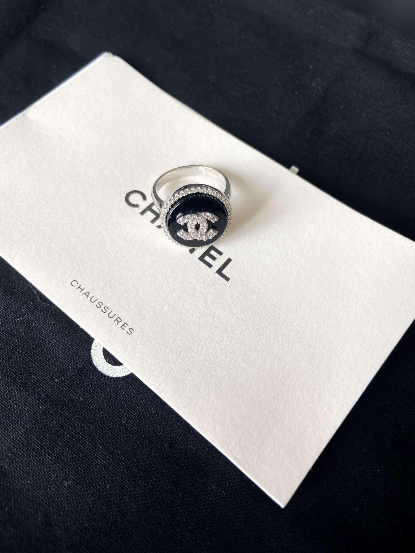 Chanel vintage 925 sterling silver enamel ring with black background and logo detail on Chanel packaging