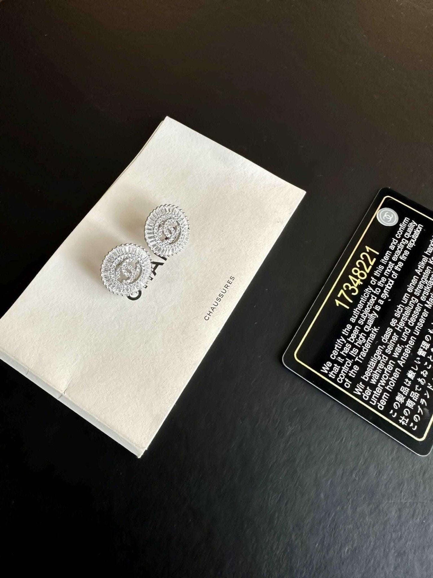 Authentic Chanel Jewelry 925 sterling silver earrings with baguette stones on white Chanel box