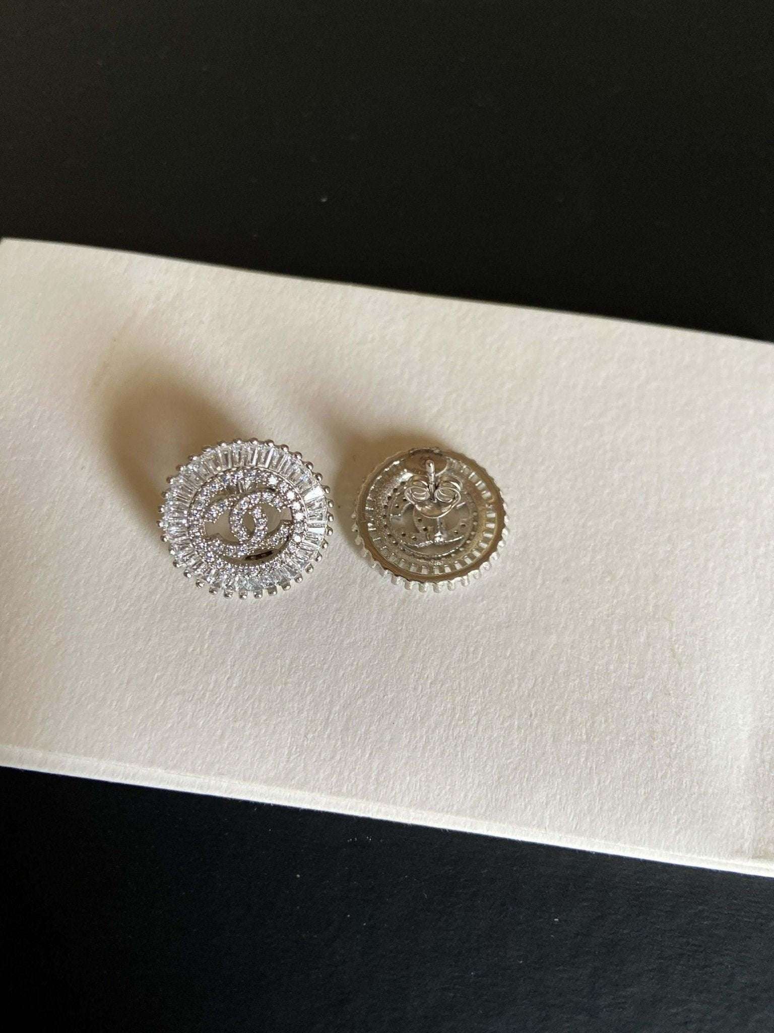 Authentic Chanel Jewelry 925 sterling silver earrings with baguette stones and logo design
