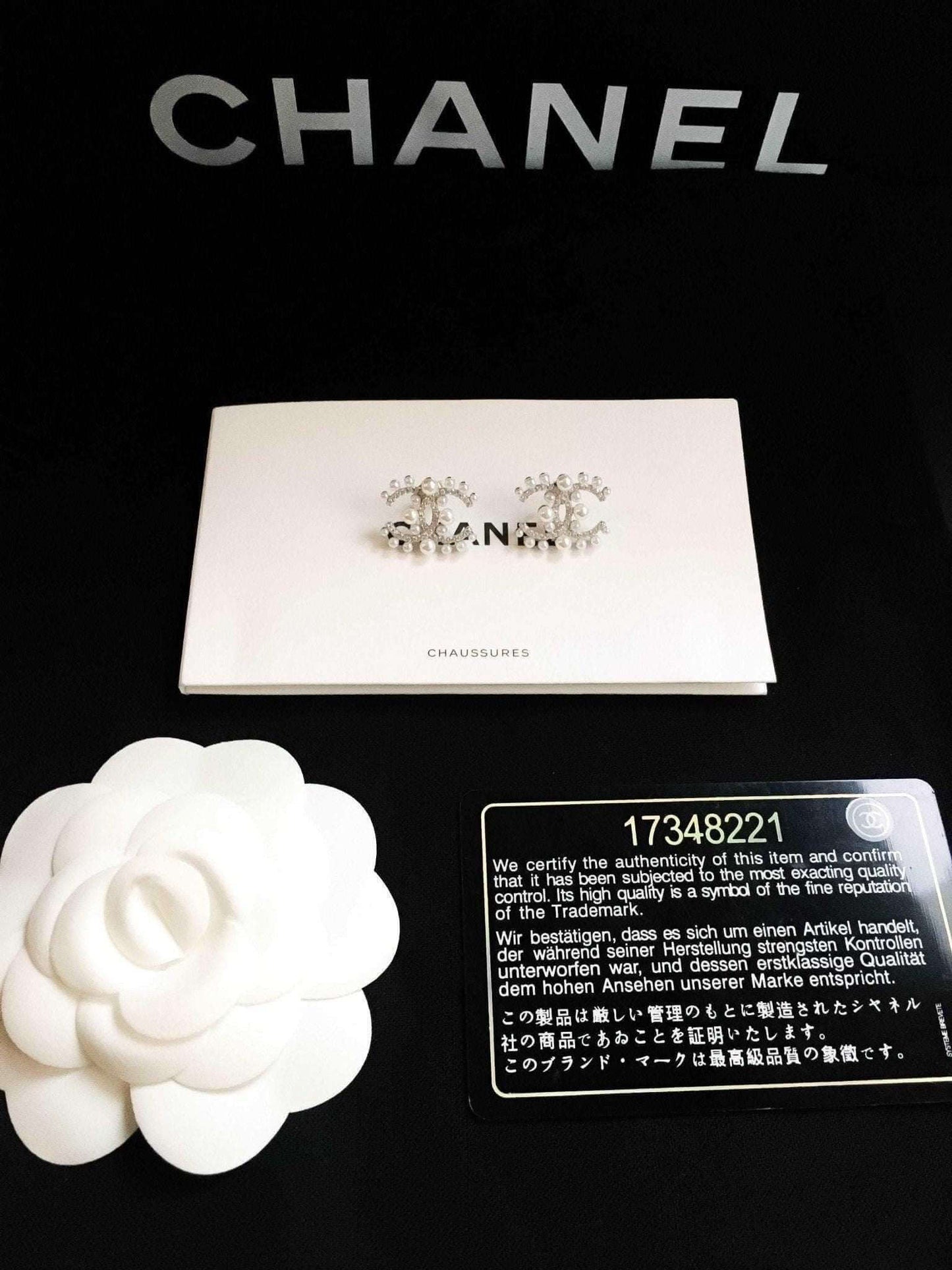 Authentic Chanel Pearl stud earrings in 925 sterling silver with rose gold accents and Italian stones displayed with authenticity card and packaging