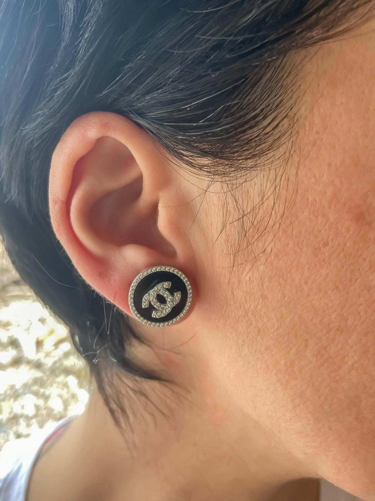 Vintage Chanel enamel 925 sterling silver round earrings with baguette stones worn on ear