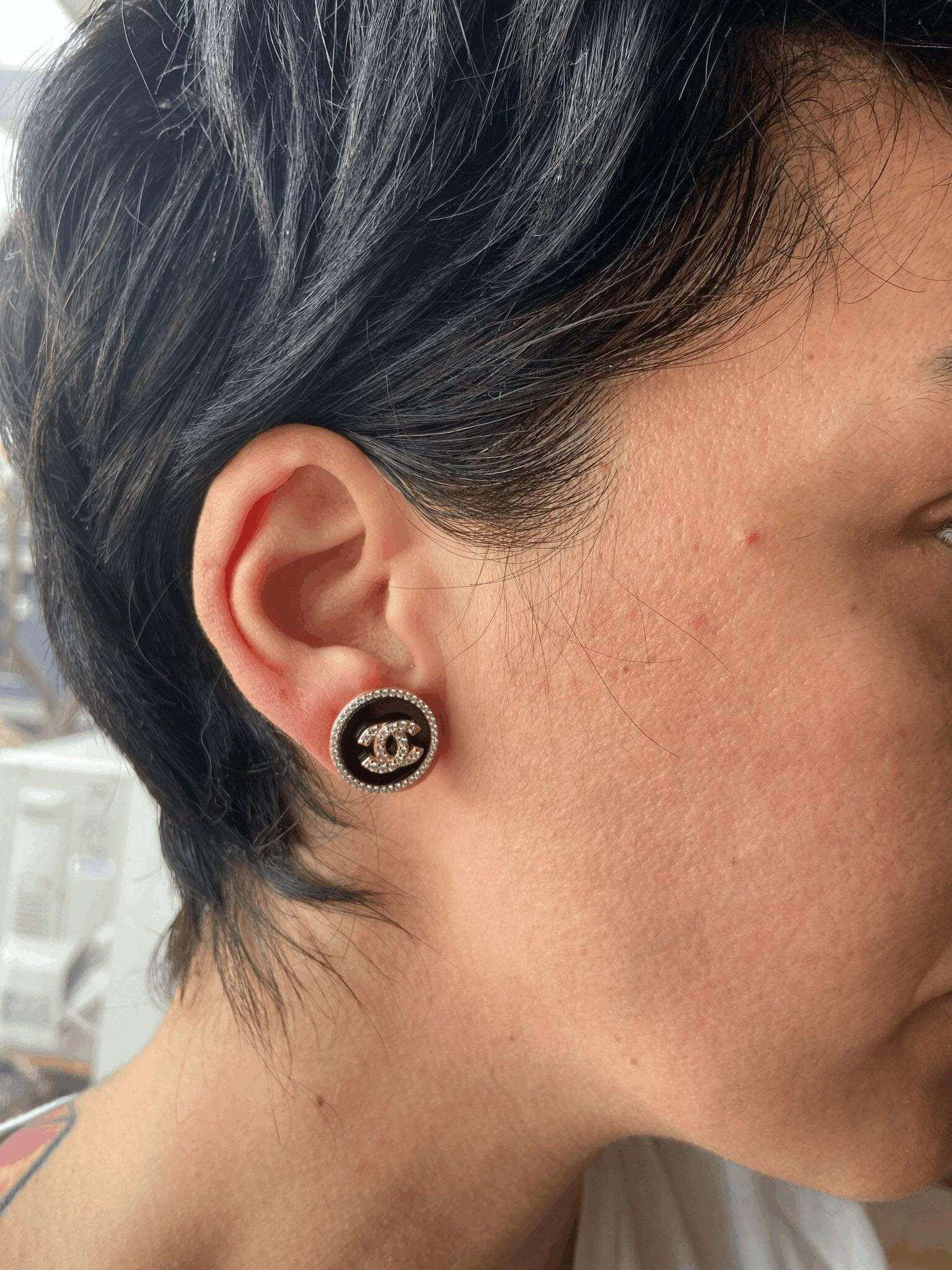 Enamel Chanel rose gold earrings with sterling silver and baguette stones worn on ear