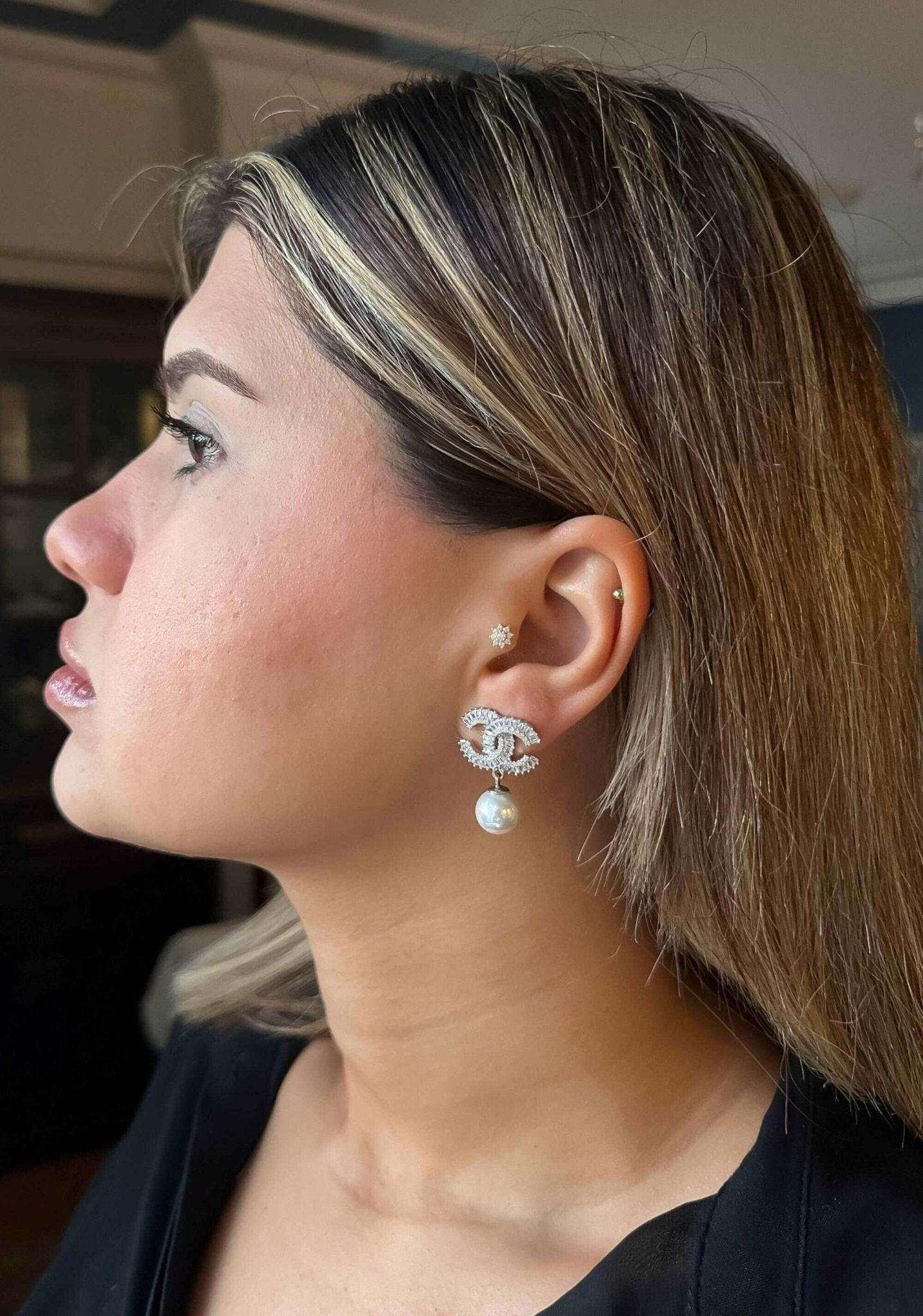 Chanel Jewelry Stud vintage earrings in 925 sterling silver with real pearl and white zircon baguette stones worn on ear