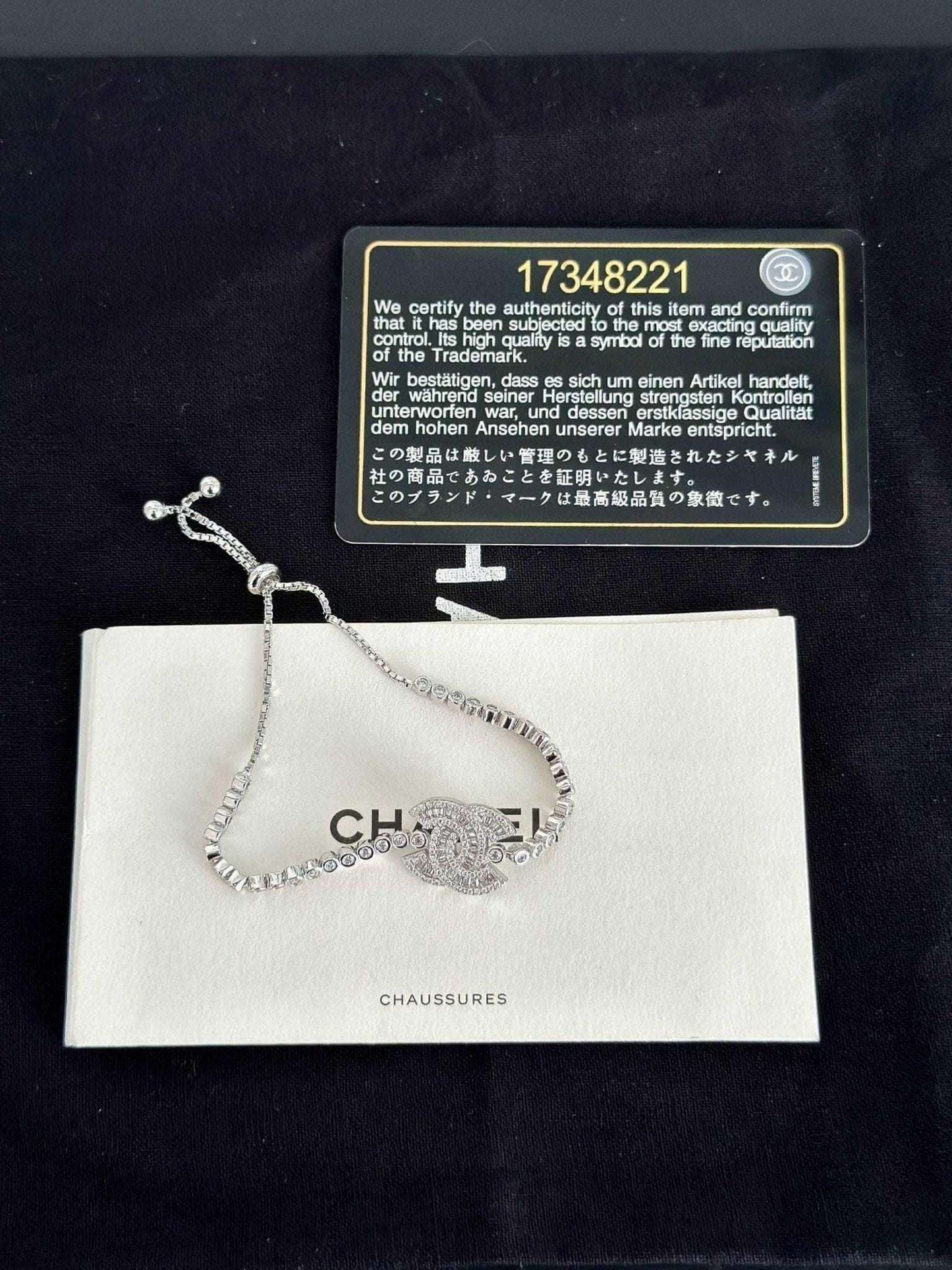 Exquisite 925 Sterling Silver Chanel Bracelet with Brilliant White Zircon Stone - Timeless Elegance on display with authenticity card.