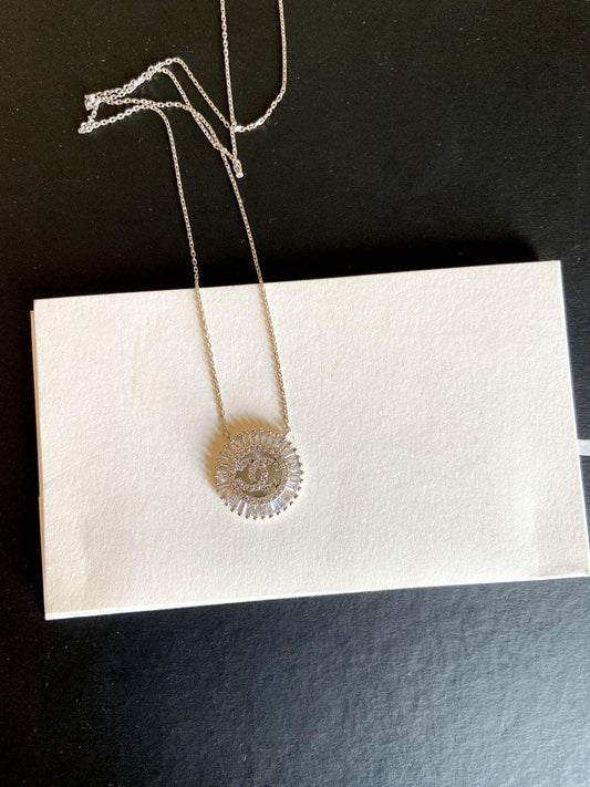 Vintage Chanel Necklace 925 sterling silver with baguette stones on chain displayed on white card