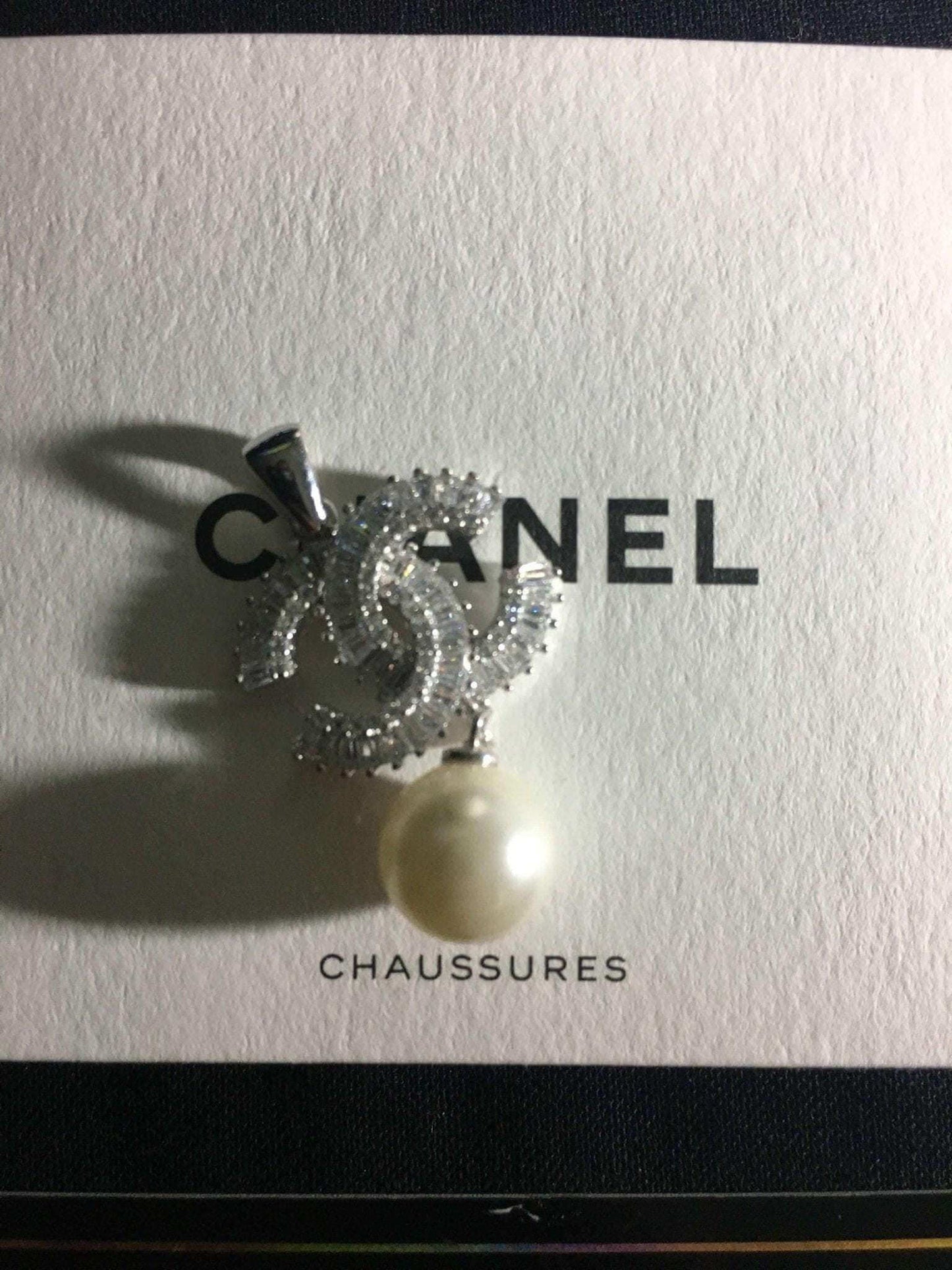 Authentic Chanel Jewelry 925 sterling silver necklace with baguette stones and pearl pendant on Chanel box