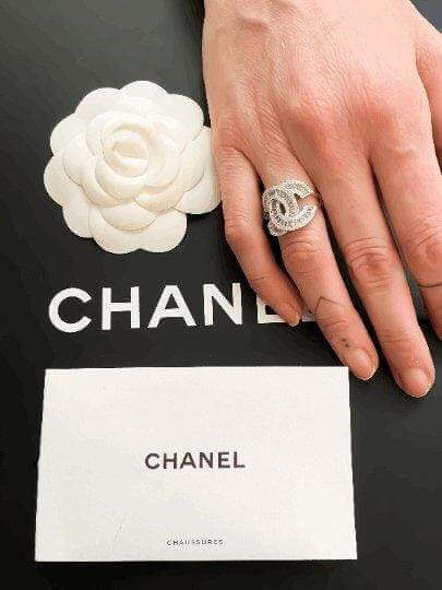 Authentic Chanel ring in 925 sterling silver with white zircon baguette stones on hand over Chanel packaging