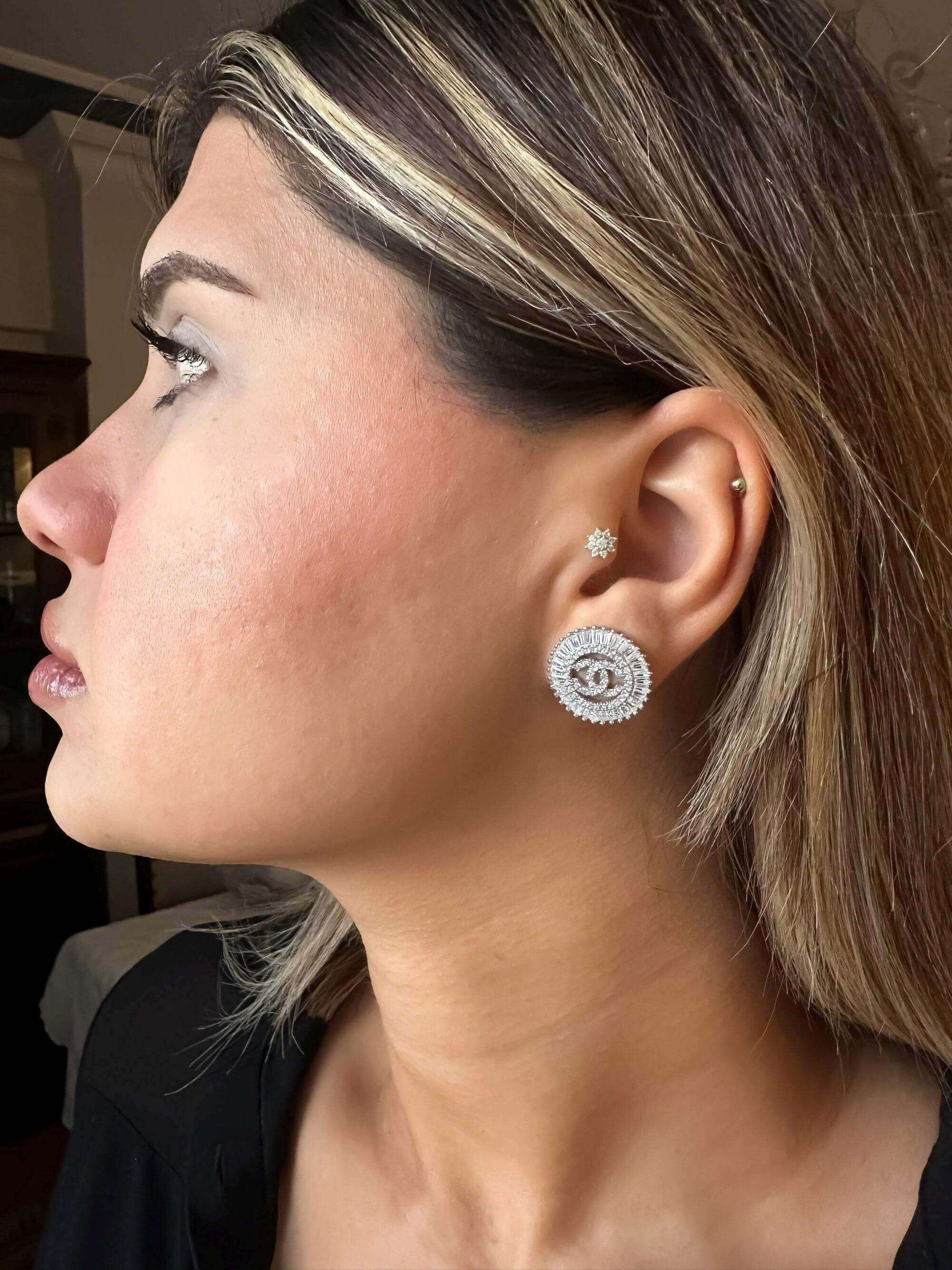 Woman wearing 925 sterling silver zircon stone Chanel baguette earrings