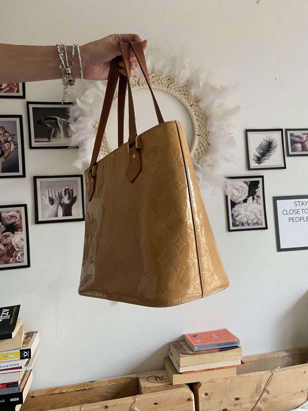 Louis Vuitton Vernis Houston yellow patent leather purse bag held by hand