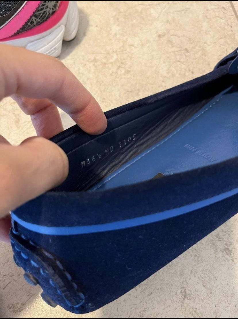 Close-up of Louis Vuitton women's shoes in royal blue suede with gold initials inside view