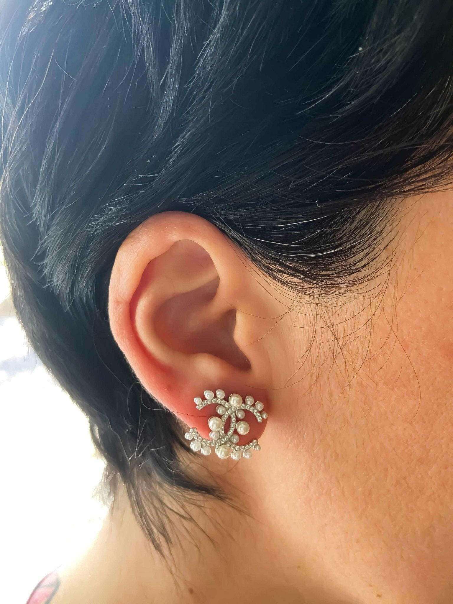 Authentic Chanel Pearl stud earrings in 925 sterling silver with rose gold and imported stones worn on ear