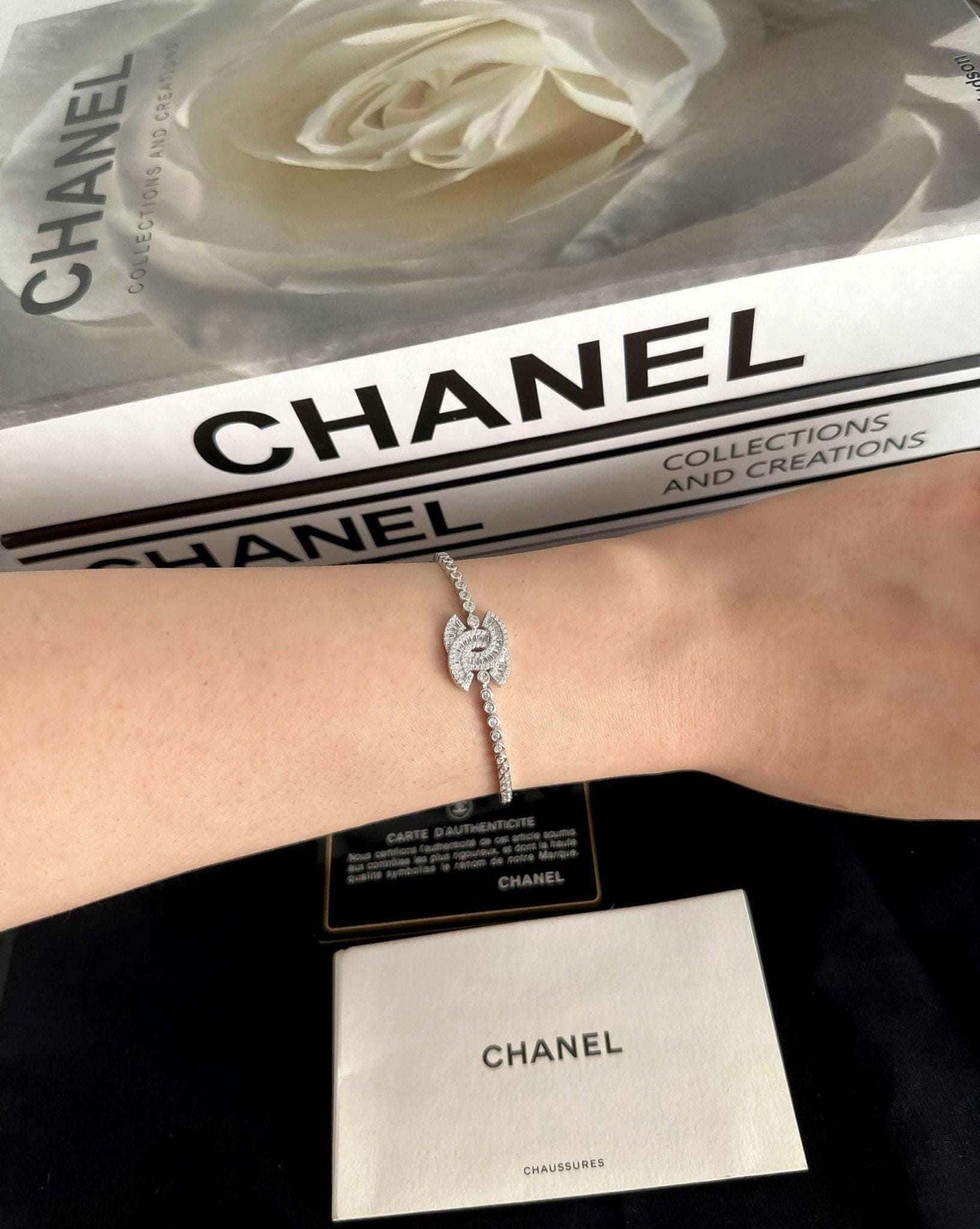 Exquisite 925 Sterling Silver Chanel Bracelet with Brilliant White Zircon Stone - Timeless Elegance worn on wrist next to Chanel packaging