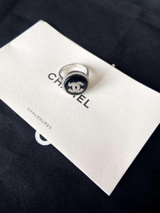 Chanel vintage 925 sterling silver enamel ring with black background and logo detail on Chanel packaging