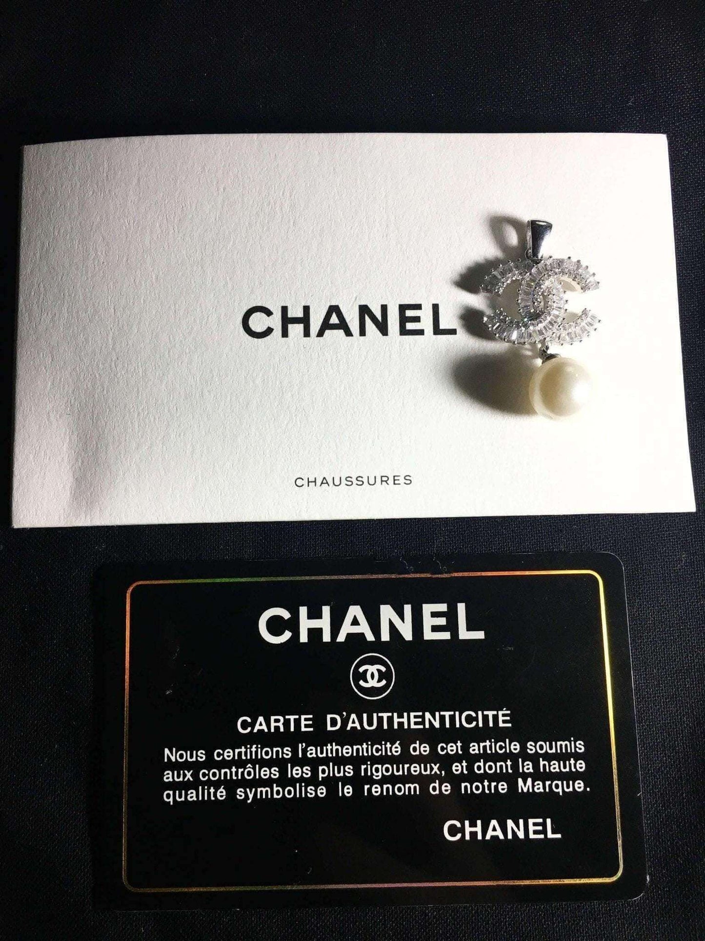 Authentic Chanel Jewelry 925 sterling silver necklace with pearl and baguette stones on Chanel authenticity card and envelope