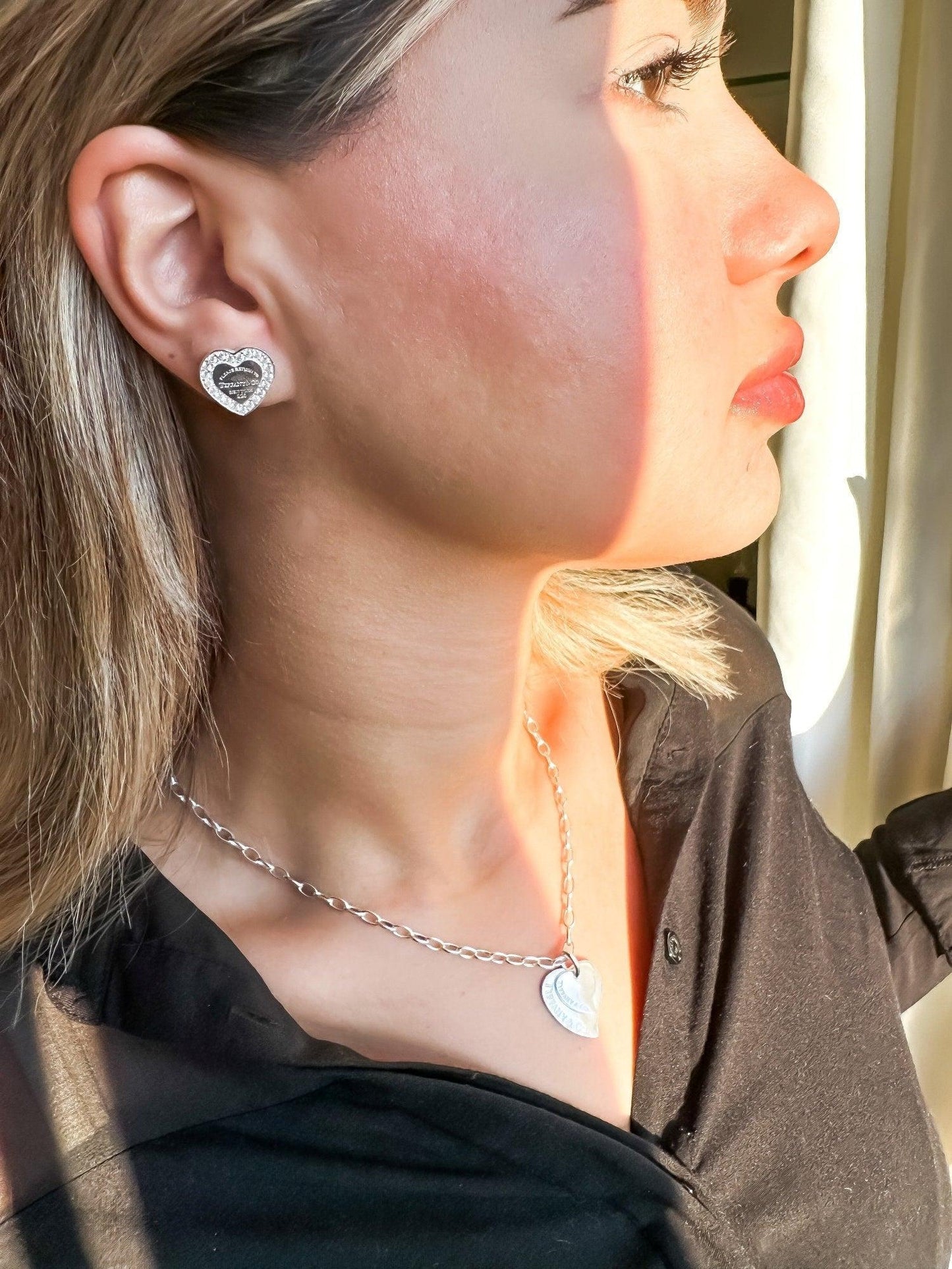 Woman wearing Tiffany&Co 925 sterling silver heart-shaped earrings and necklace jewelry set