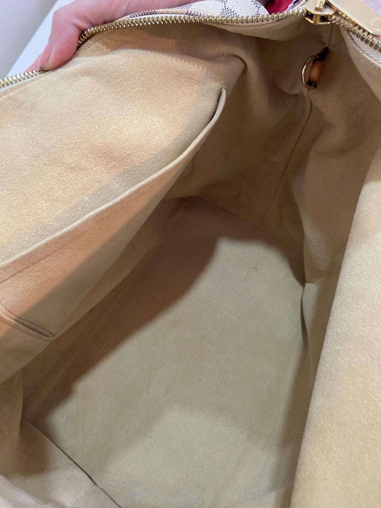 Louis Vuitton Damier Azur Saleya MM tote bag interior view showing clean beige lining and pocket