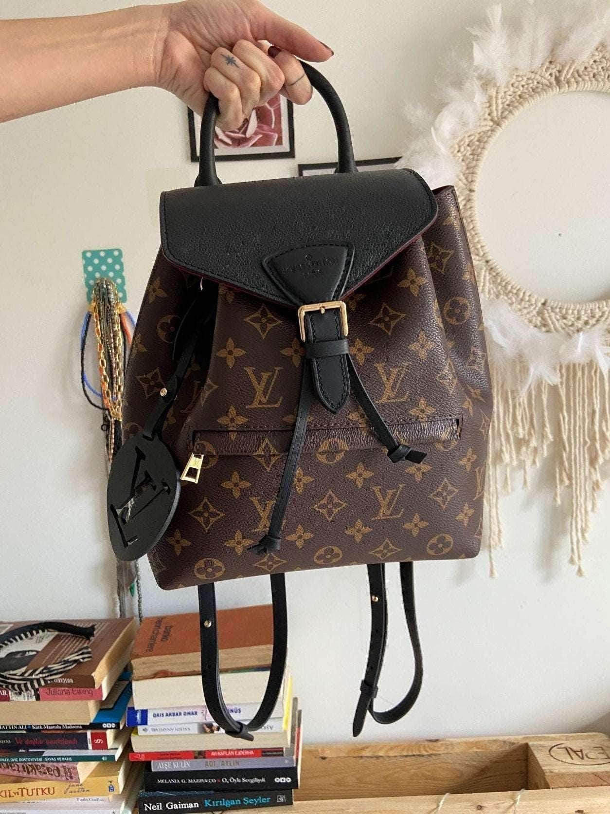 Louis Vuitton Monogram MONTSOURIS Backpack in brown monogram canvas with black leather flap and gold buckle