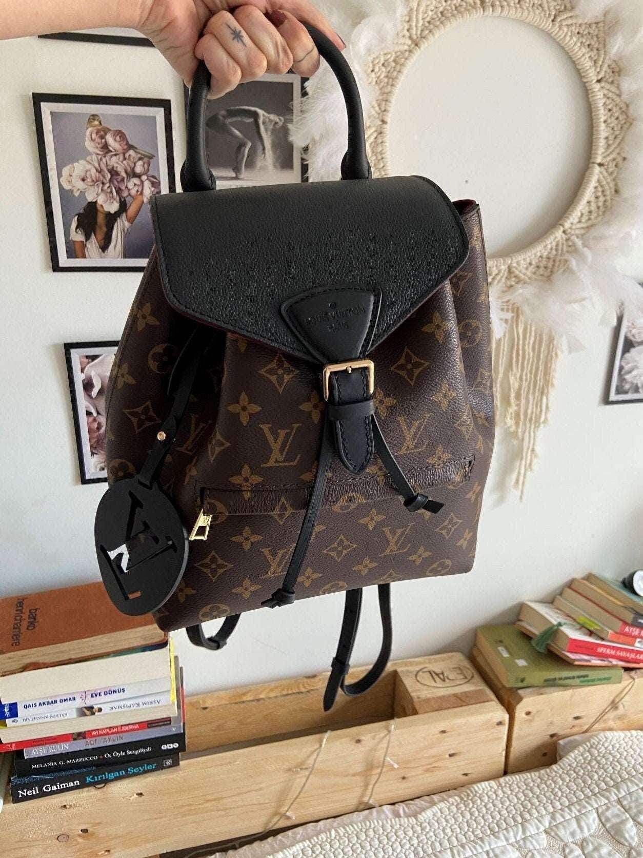 Louis Vuitton Monogram MONTSOURIS Backpack with black leather flap and gold buckle, authentic luxury bag in excellent condition
