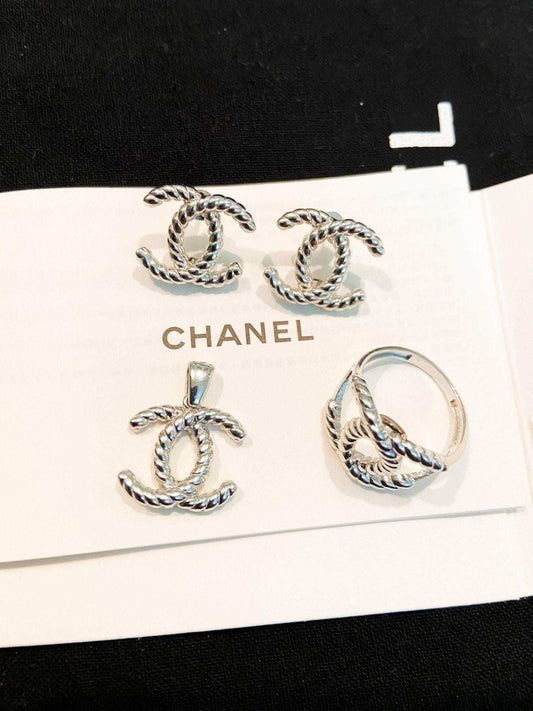 Vintage Chanel Set 925 sterling silver jewelry with twisted design including earrings, pendant, and ring on Chanel card